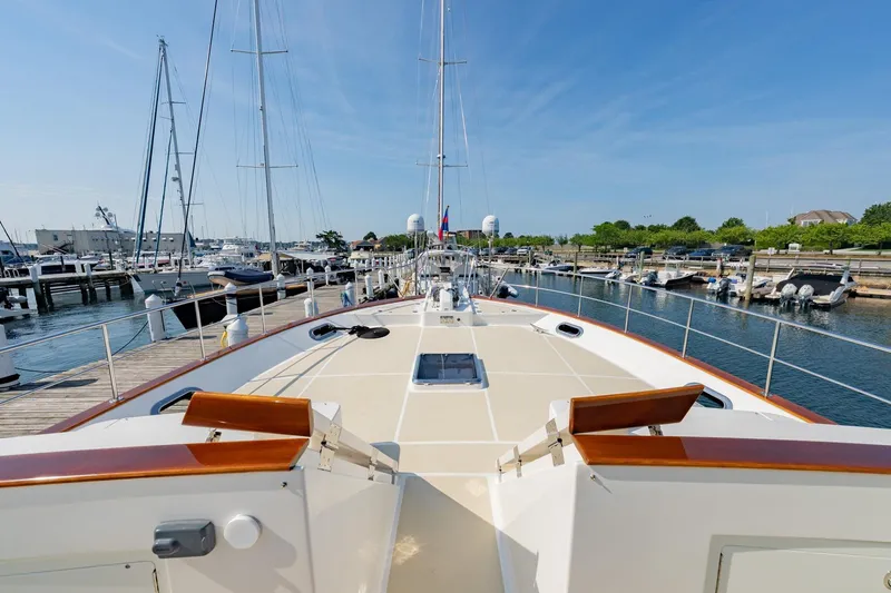 Slide: The Image of 2016 Grand Banks 72 Aleutian RP yacht docked in a marina, clear blue sky. - 18