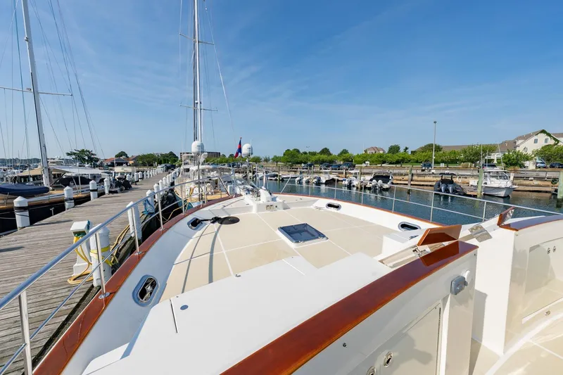 Slide: The Image of 2016 Grand Banks 72 Aleutian RP yacht docked at a marina under clear blue skies. - 19