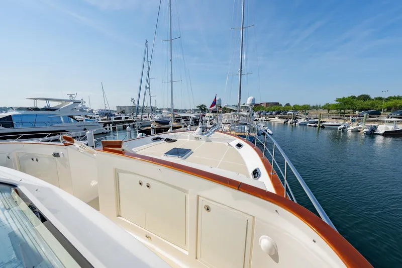 Slide: The Image of 2016 Grand Banks 72 Aleutian RP yacht docked at a marina under clear blue skies. - 20