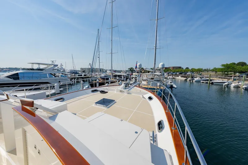 Slide: The Image of 2016 Grand Banks 72 Aleutian RP yacht docked at a marina under clear blue skies. - 21