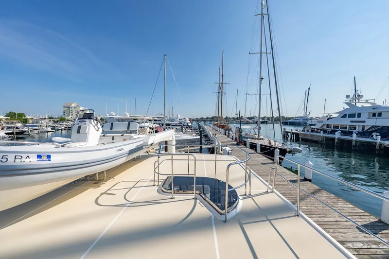 Slide: The Image of 2016 Grand Banks 72 Aleutian RP yacht docked at a marina under clear blue skies. - 22