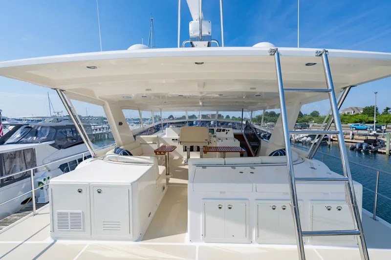 Slide: The Image of 2016 Grand Banks 72 Aleutian RP yacht deck with grill and ladder, docked at marina. - 27