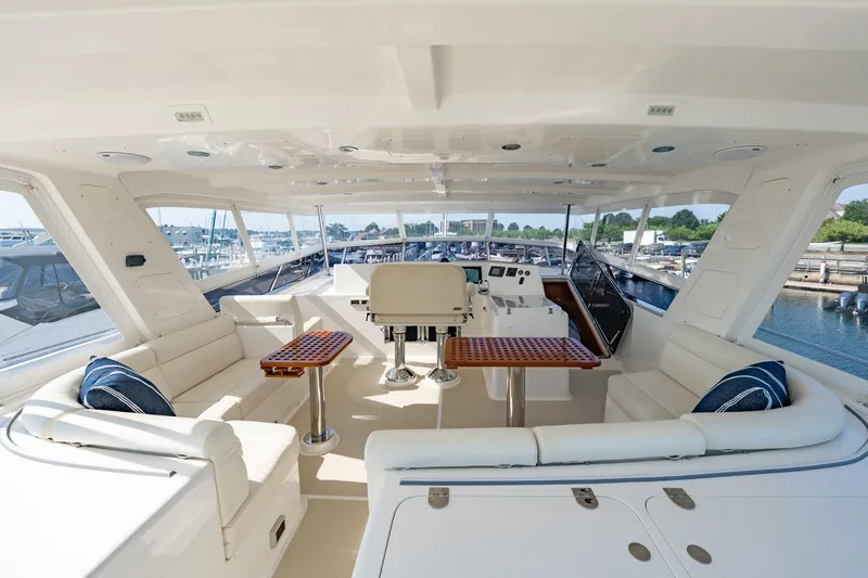 Slide: The Image of Flybridge of 2016 Grand Banks 72 Aleutian RP yacht, featuring spacious seating and helm station. - 28