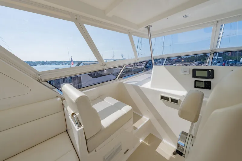 Slide: The Image of Luxurious 2016 Grand Banks 72 Aleutian RP yacht interior with plush seating and marina view. - 35