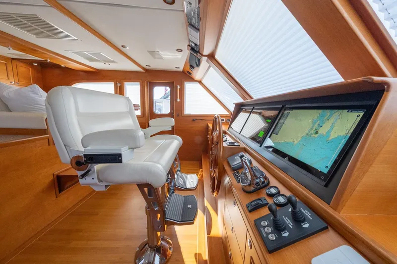 Slide: The Image of Luxurious helm of 2016 Grand Banks 72 Aleutian RP yacht with plush seating and wood finish. - 70
