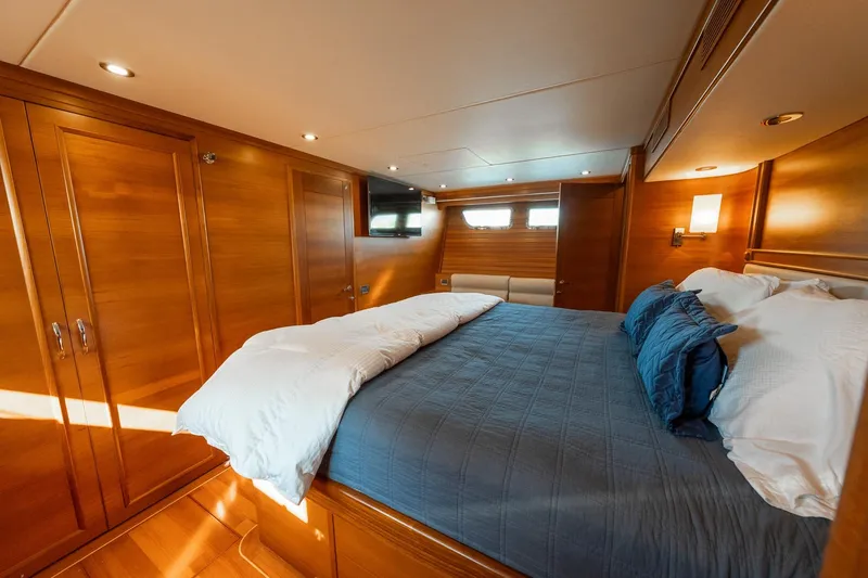 Slide: The Image of Luxurious 2016 Grand Banks 72 Aleutian RP yacht bedroom with elegant wood finish. - 76