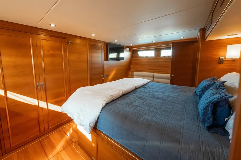 Slide: The Image of Luxurious cabin interior of 2016 Grand Banks 72 Aleutian RP yacht with wood paneling. - 77