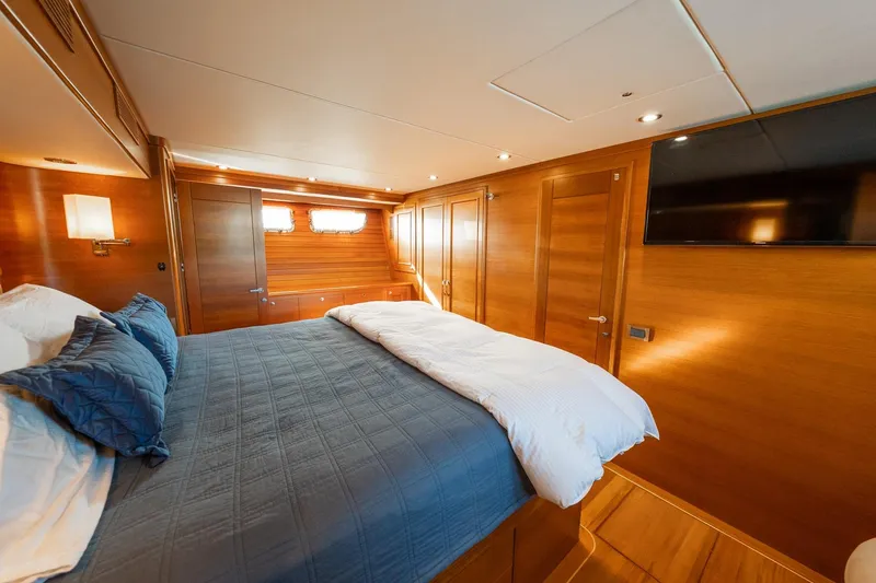 Slide: The Image of Luxurious cabin interior of 2016 Grand Banks 72 Aleutian RP yacht with wood paneling. - 78
