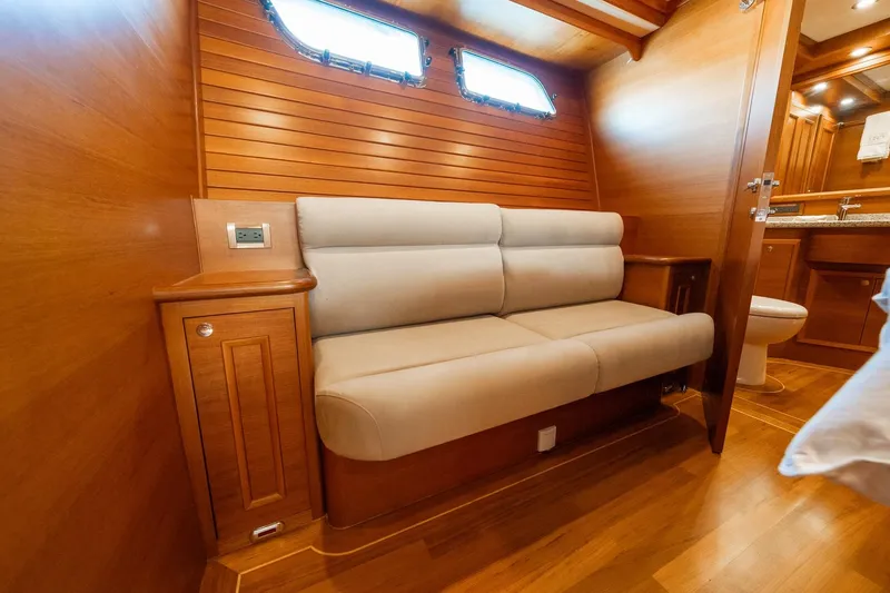 Slide: The Image of Luxurious cabin interior of 2016 Grand Banks 72 Aleutian RP yacht, featuring elegant wood finishes. - 79