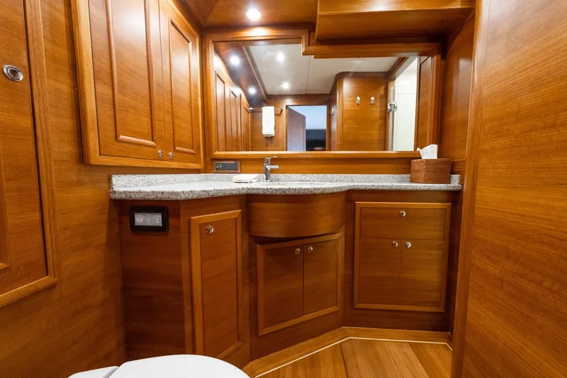 Slide: The Image of Luxurious interior of 2016 Grand Banks 72 Aleutian RP yacht with wooden paneling and plush seating. - 80