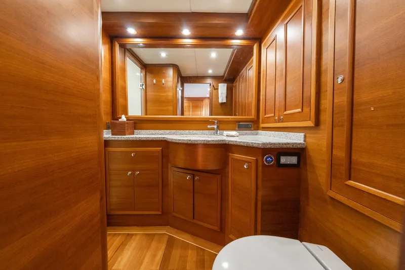 Slide: The Image of Luxurious bathroom interior of 2016 Grand Banks 72 Aleutian RP yacht with wooden accents. - 86