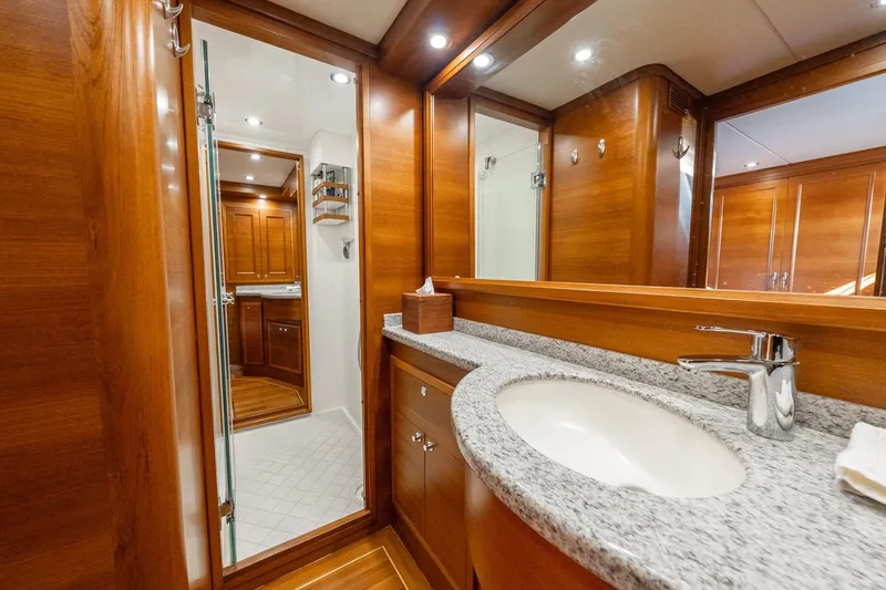 Slide: The Image of Luxurious wooden interior of 2016 Grand Banks 72 Aleutian RP yacht bathroom. - 89