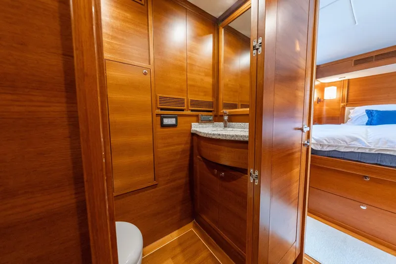 Slide: The Image of Luxurious wooden interior of 2016 Grand Banks 72 Aleutian RP yacht bathroom. - 96