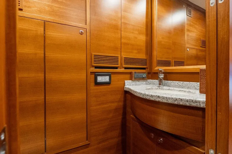 Slide: The Image of Luxurious wooden interior of 2016 Grand Banks 72 Aleutian RP yacht bathroom. - 98