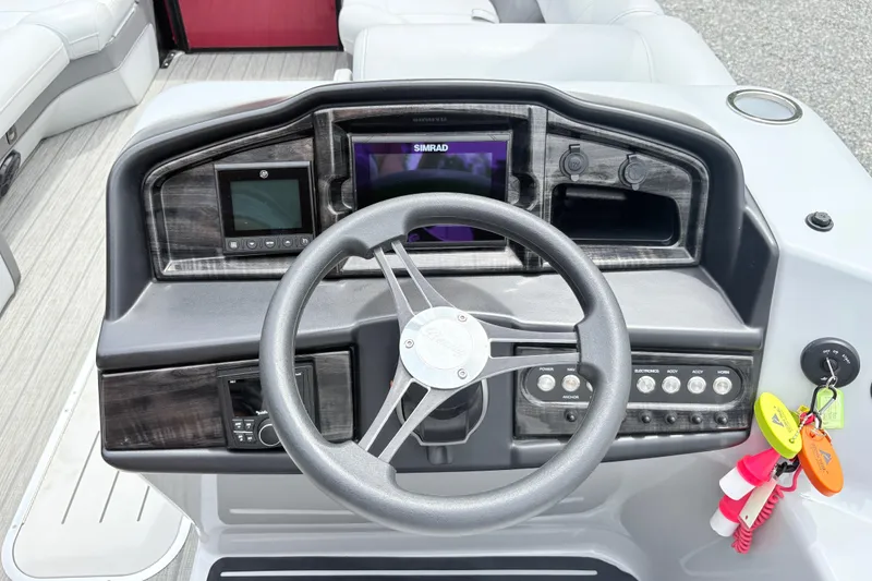 Slide: The Image of 2022 Bentley Pontoons 223 Elite dashboard with steering wheel and control panel. - 12