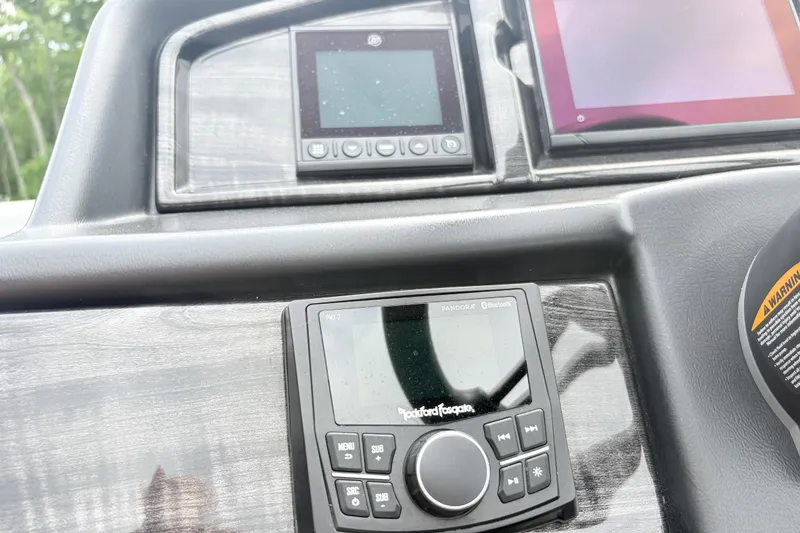 Slide: The Image of Dashboard of 2022 Bentley Pontoons 223 Elite with control panels and warning label. - 13