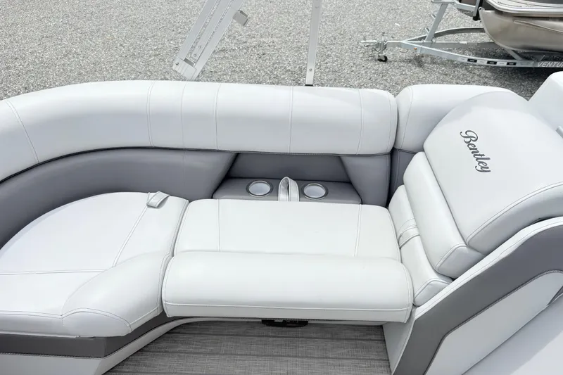 Slide: The Image of 2022 Bentley Pontoons 223 Elite interior with luxurious white seating and cup holders. - 17