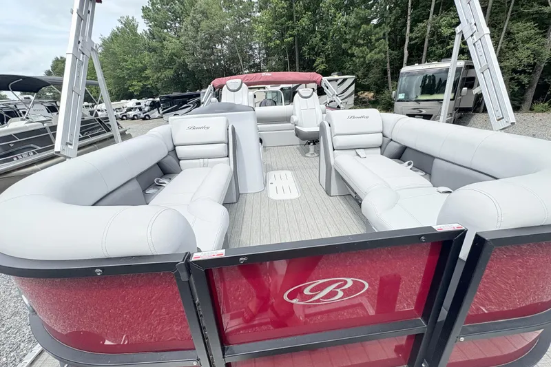 Slide: The Image of 2022 Bentley Pontoons 223 Elite with luxurious seating, docked near trees and RVs. - 23