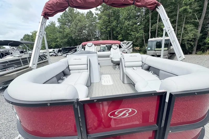Slide: The Image of 2022 Bentley Pontoons 223 Elite with red exterior and spacious seating, parked outdoors. - 24