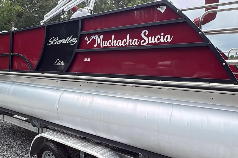 Slide: The Image of 2022 Bentley Pontoons 223 Elite, red and silver, on trailer, side view. - 25