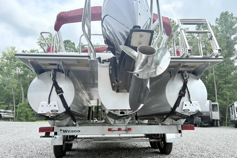 Slide: The Image of 2022 Bentley Pontoons 223 Elite on trailer, rear view with propeller and pontoons. - 5