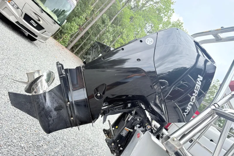 Slide: The Image of 2022 Bentley Pontoons 223 Elite with Mercury outboard motor in a gravel lot. - 6