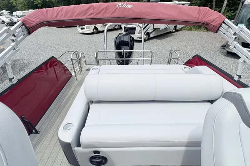 Slide: The Image of 2022 Bentley Pontoons 223 Elite with red canopy and white seating, parked outdoors. - 8