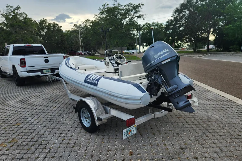 Slide: The Image of 2019 Novurania DL 400 boat on trailer, equipped with Yamaha outboard motor, parked outdoors. - 10