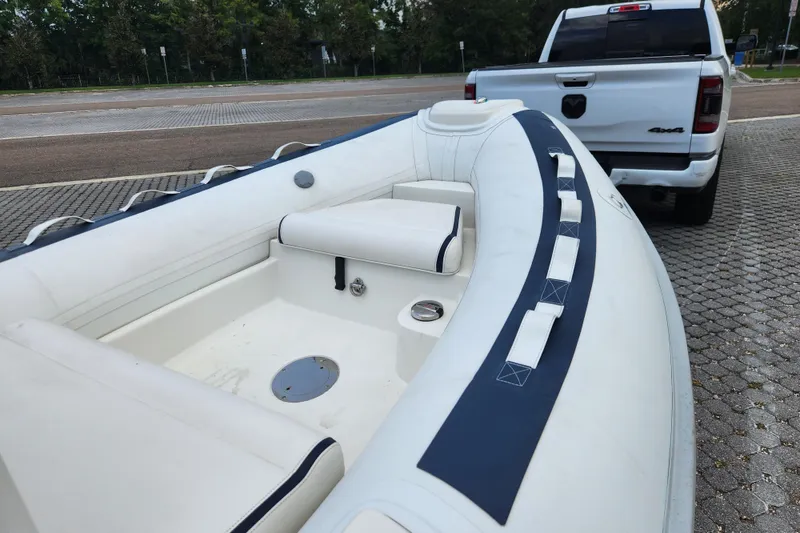 Slide: The Image of 2019 Novurania DL 400 boat on trailer, parked near a white truck. - 13