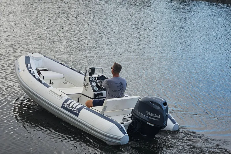 Slide: The Image of 2019 Novurania DL 400 boat with Yamaha engine on calm water. - 2