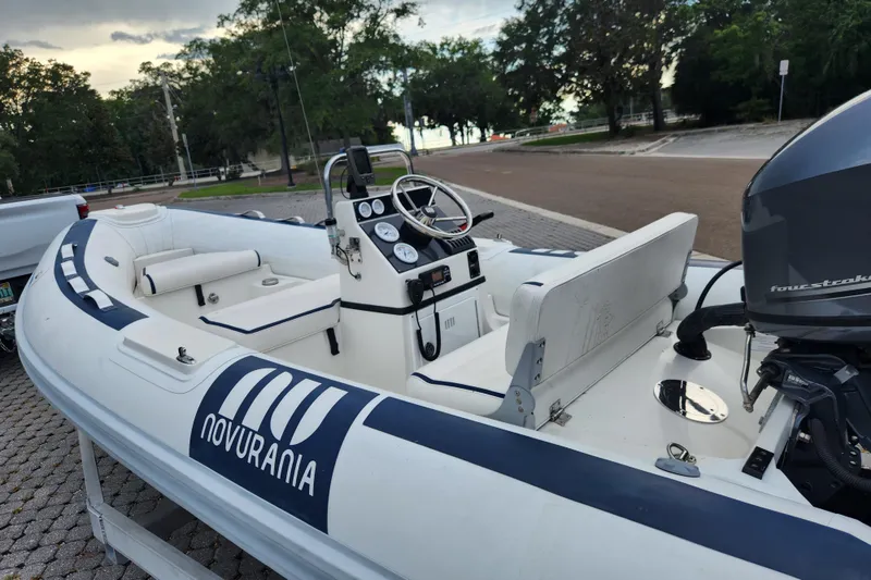 Slide: The Image of 2019 Novurania DL 400 inflatable boat with outboard motor, parked on a trailer. - 22