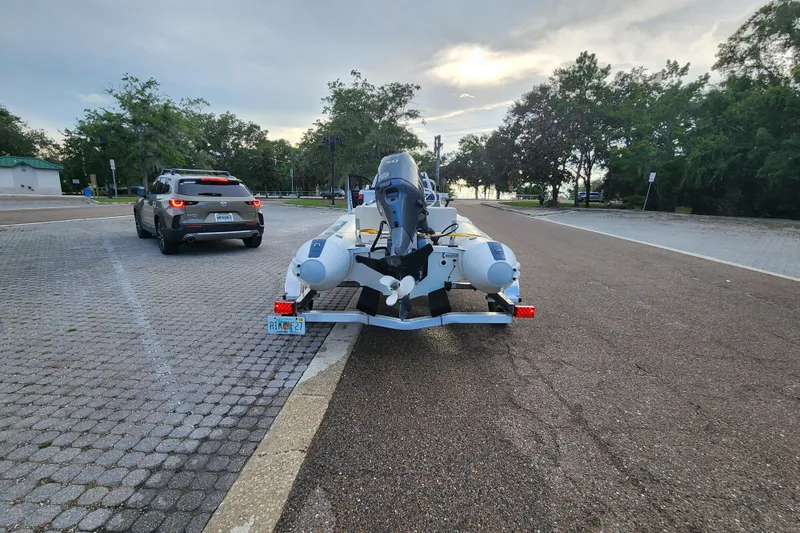 Slide: The Image of 2019 Novurania DL 400 boat on trailer in parking lot, overcast sky. - 28