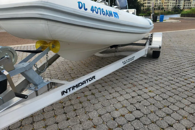 Slide: The Image of 2019 Novurania DL 400 boat on Intimidator trailer, parked on cobblestone surface. - 29
