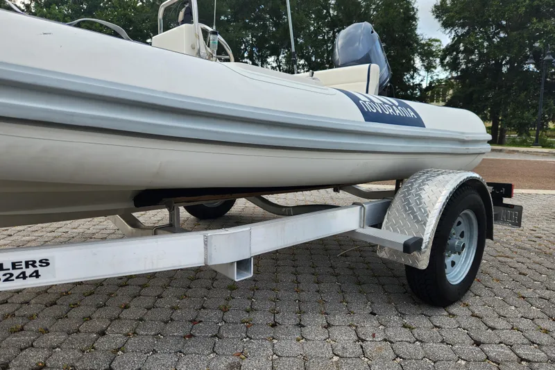 Slide: The Image of 2019 Novurania DL 400 boat on trailer, parked on cobblestone pavement. - 30