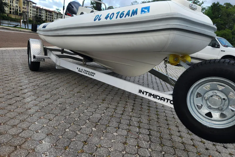 Slide: The Image of 2019 Novurania DL 400 boat on trailer, parked on paved surface. - 32