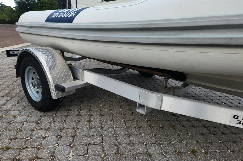 Slide: The Image of 2019 Novurania DL 400 boat on a trailer, parked on a paved surface. - 33
