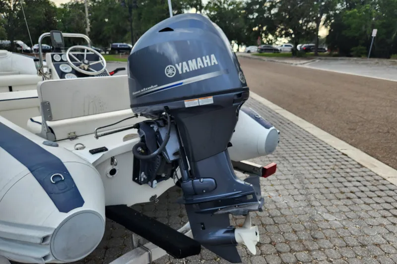 Slide: The Image of 2019 Novurania DL 400 boat with Yamaha outboard motor, parked on cobblestone pavement. - 35