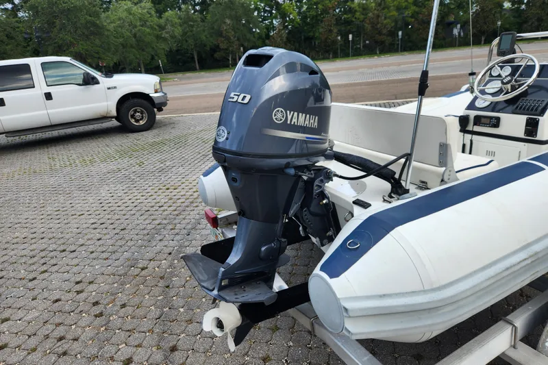 Slide: The Image of Novurania DL 400 boat with Yamaha 50 outboard motor, parked on paved area. - 37