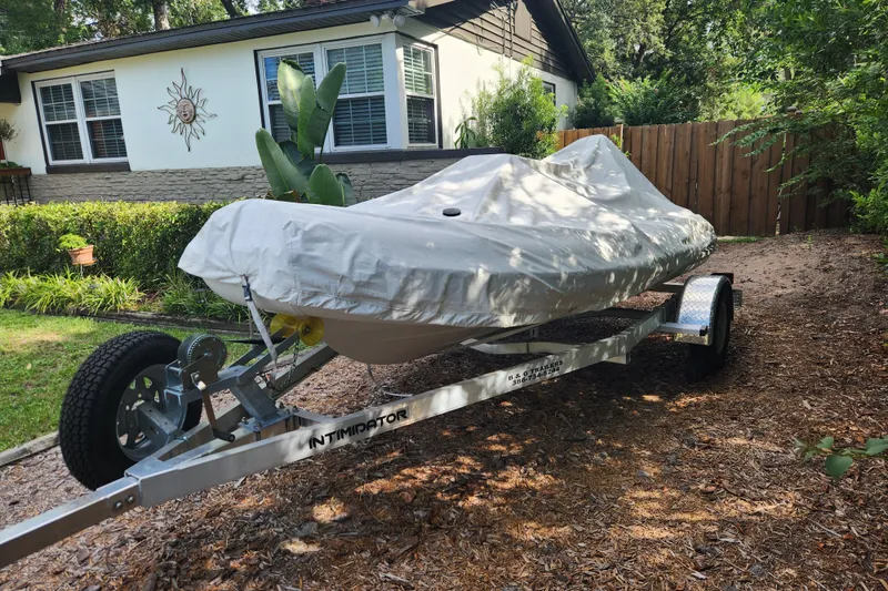 Slide: The Image of Covered 2019 Novurania DL 400 boat on trailer in residential driveway. - 4