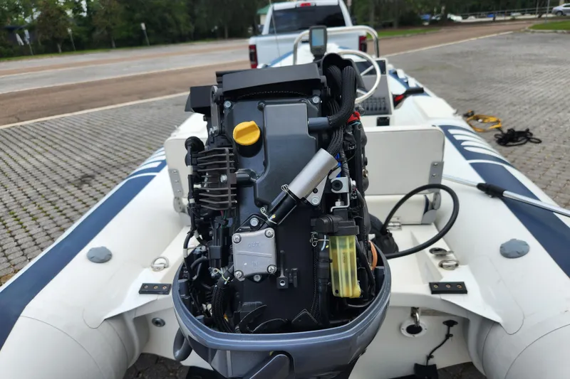 Slide: The Image of 2019 Novurania DL 400 boat with exposed engine, parked on a paved area. - 47