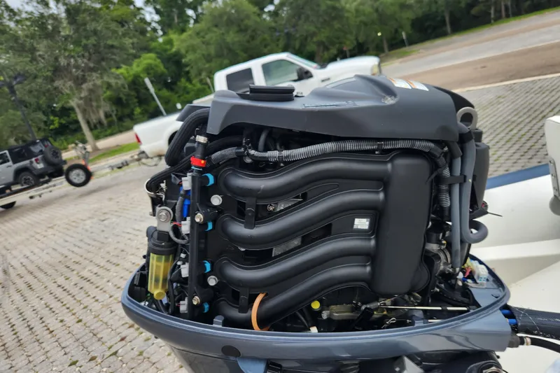 Slide: The Image of 2019 Novurania DL 400 boat engine, detailed view, outdoors with vehicles in background. - 48