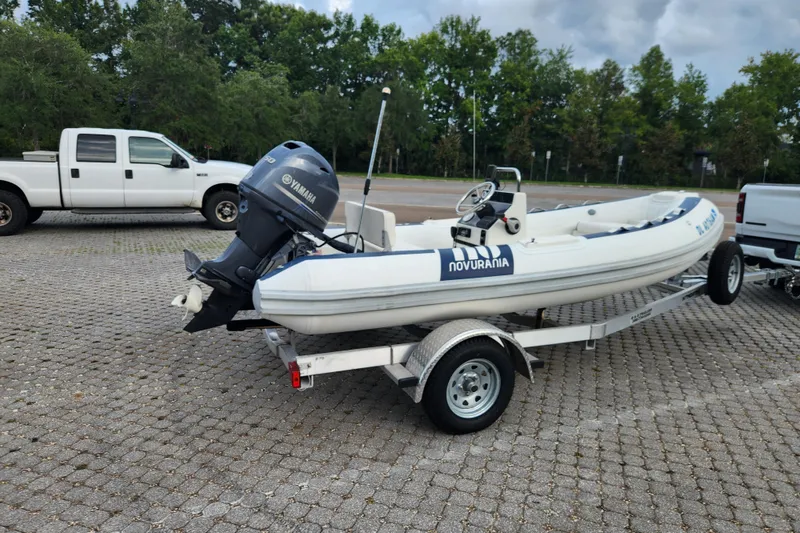Slide: The Image of 2019 Novurania DL 400 boat on trailer with Yamaha outboard motor in parking lot. - 7