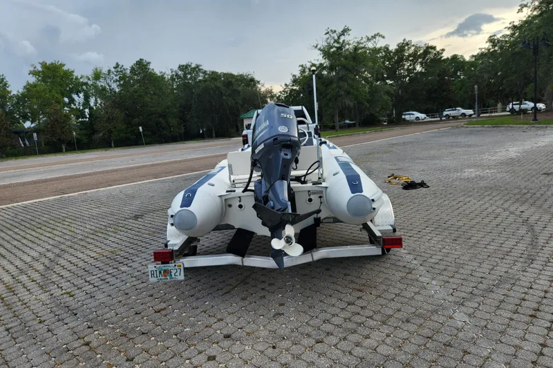 Slide: The Image of 2019 Novurania DL 400 boat on trailer with Yamaha outboard motor in parking lot. - 8