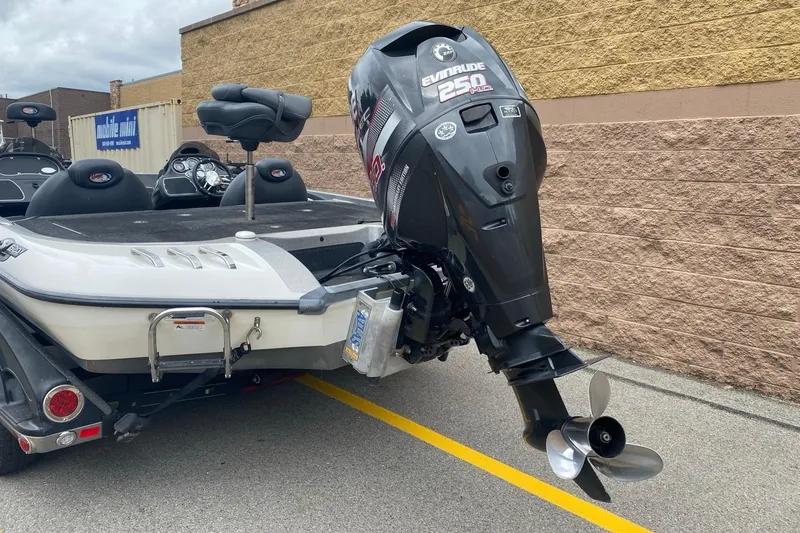 Slide: The Image of 2009 Ranger Z520 Comanche boat with Evinrude 250 motor, parked outdoors. - 4