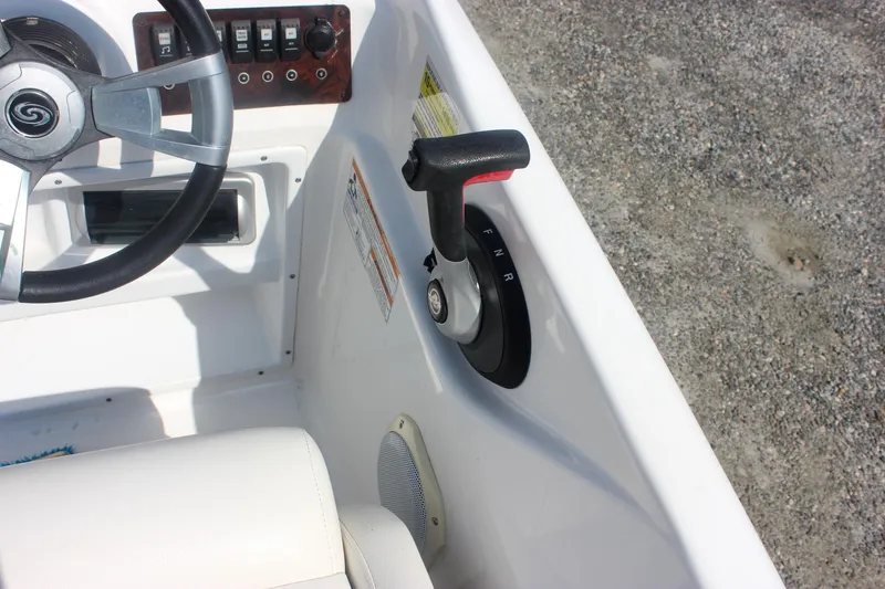 Slide: The Image of 2013 Hurricane SunDeck Sport 188 OB boat steering wheel and throttle controls. - 10