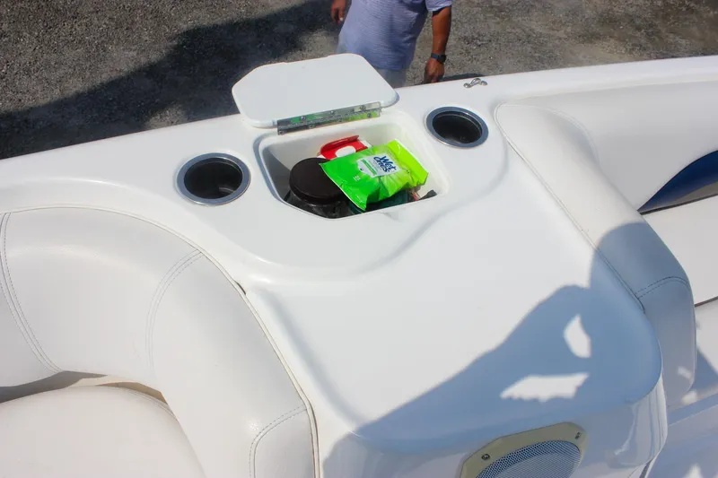 Slide: The Image of 2013 Hurricane SunDeck Sport 188 OB boat interior with storage compartment and cup holders. - 12