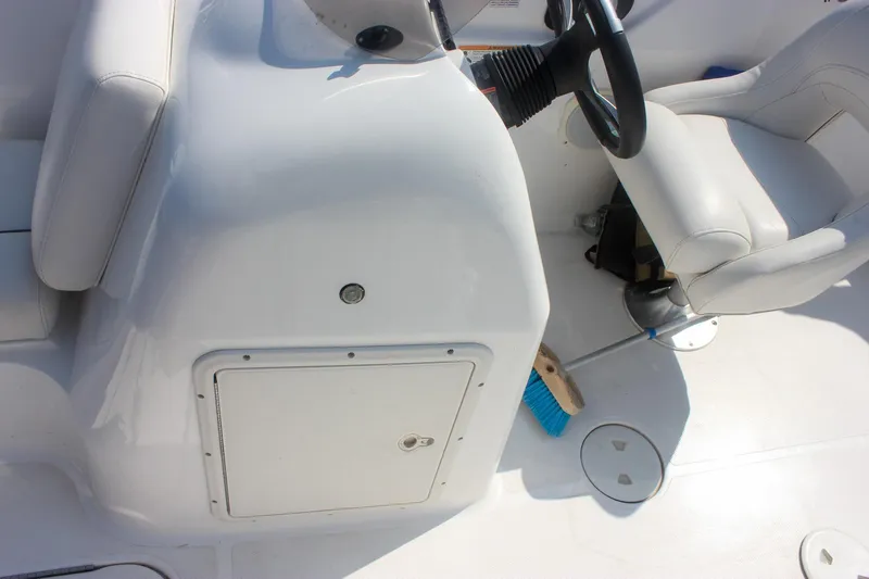 Slide: The Image of 2013 Hurricane SunDeck Sport 188 OB boat interior with steering wheel and seating. - 13