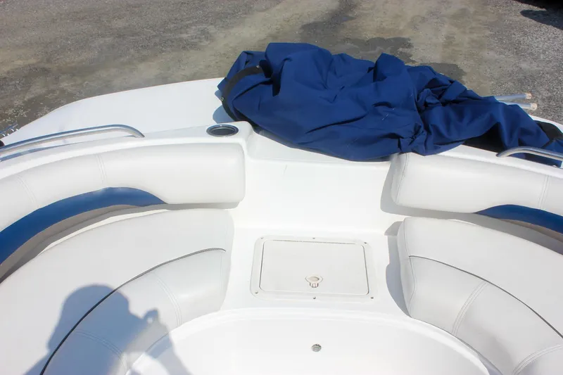 Slide: The Image of 2013 Hurricane SunDeck Sport 188 OB boat interior with white seating and blue cover. - 17