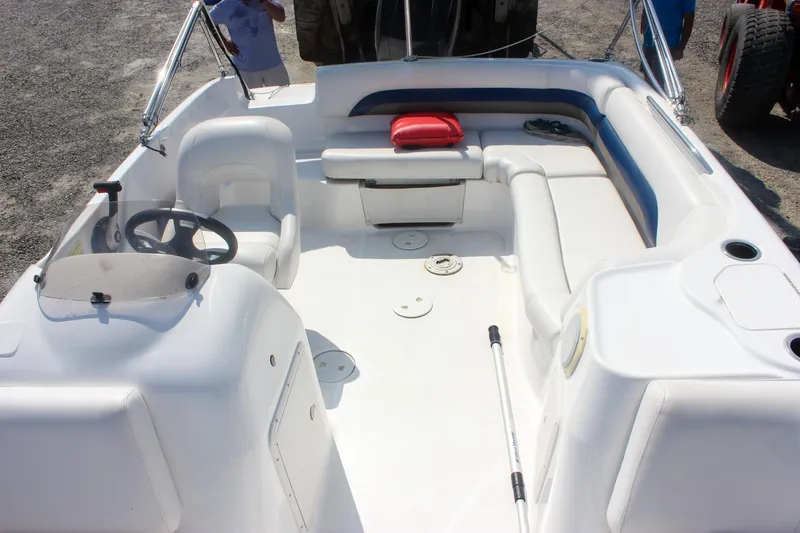 Slide: The Image of 2013 Hurricane SunDeck Sport 188 OB boat interior with seating and steering wheel. - 18