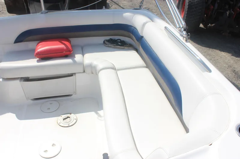 Slide: The Image of 2013 Hurricane SunDeck Sport 188 OB boat interior with white and blue seating, red cushion. - 7